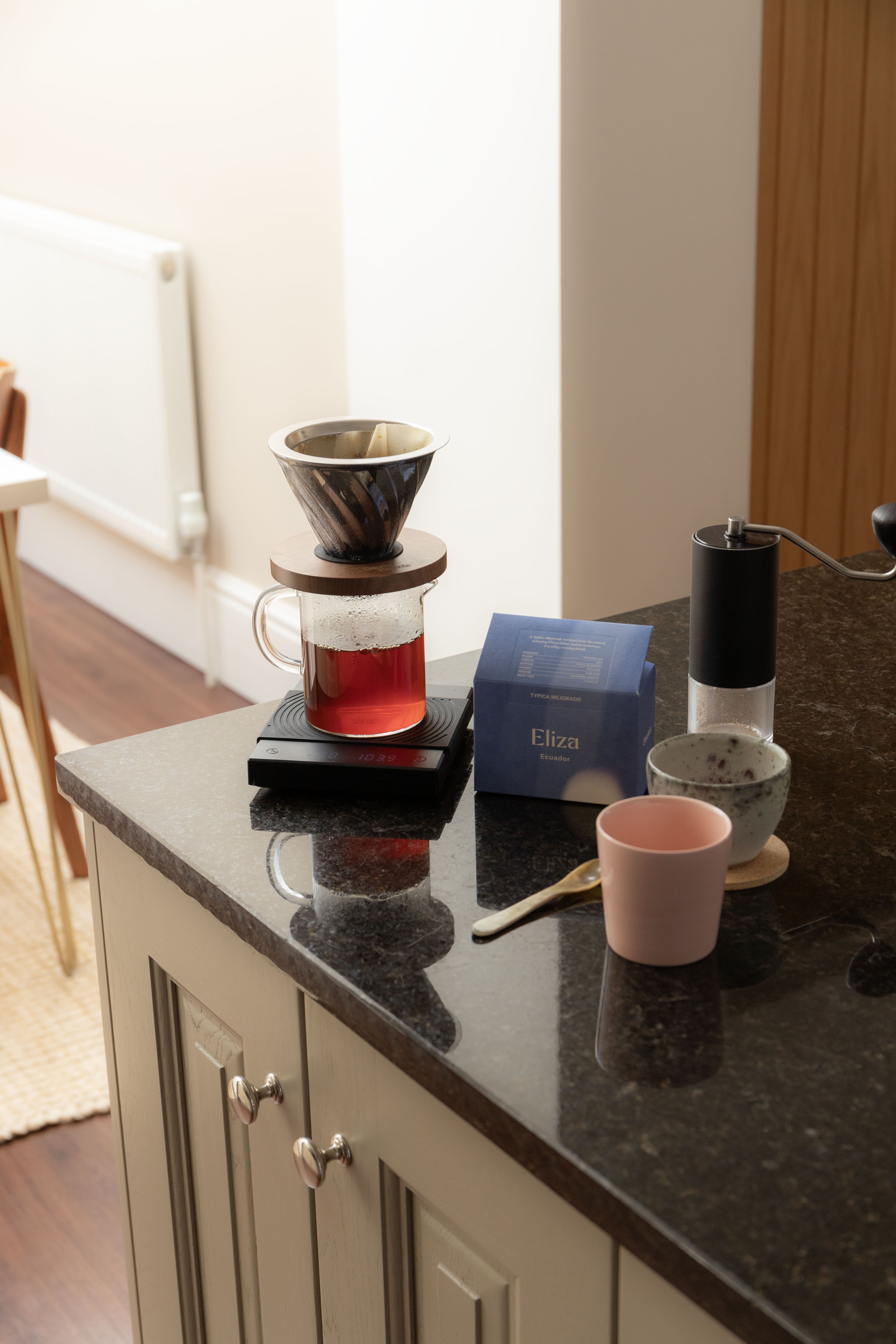 Glass coffee mug on counter top near coffee